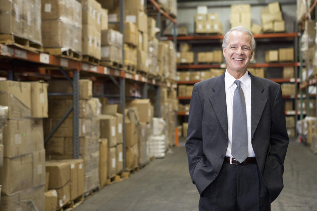 Smiling businessman in warehouse